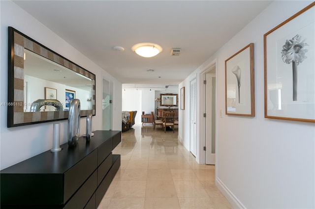 hall featuring light tile patterned floors