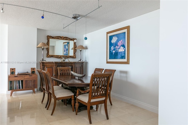 dining space featuring a textured ceiling