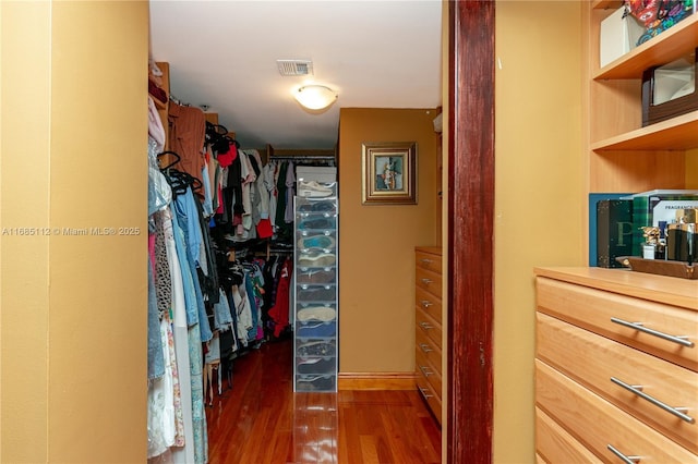 spacious closet featuring dark hardwood / wood-style floors