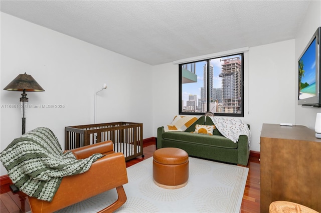 living room with wood-type flooring and a textured ceiling