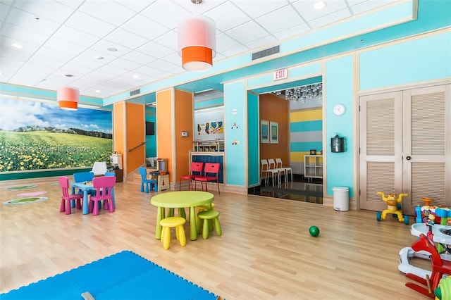 recreation room with hardwood / wood-style floors