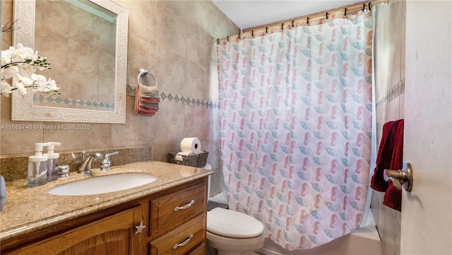 full bathroom featuring vanity, toilet, tile walls, and shower / bath combo with shower curtain