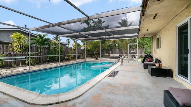 view of swimming pool featuring a lanai and a patio area