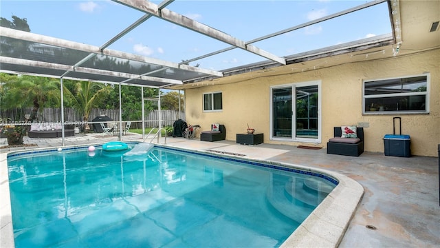 view of swimming pool with glass enclosure and a patio