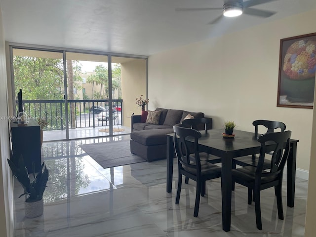 dining space with ceiling fan and floor to ceiling windows