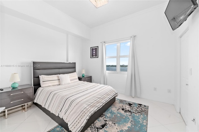 bedroom featuring crown molding and light tile patterned floors