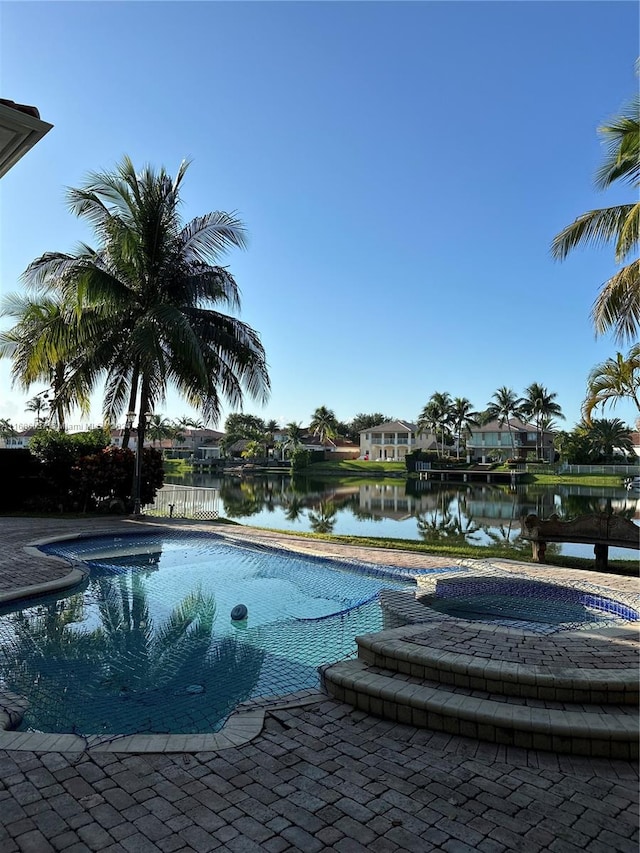 view of pool with a water view