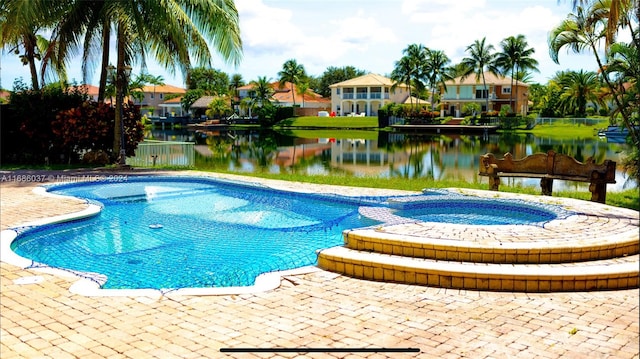 view of swimming pool with a water view