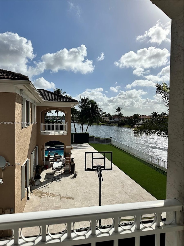 exterior space featuring a patio area and a water view