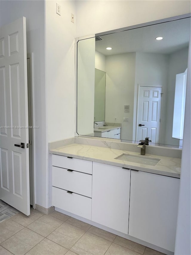 bathroom with tile patterned flooring and vanity