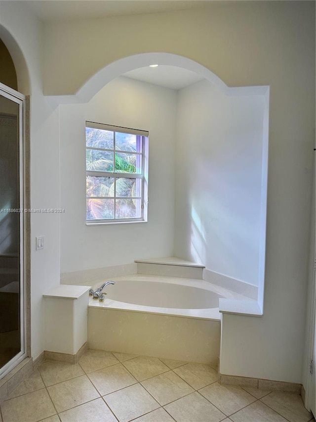 bathroom featuring tile patterned flooring and shower with separate bathtub