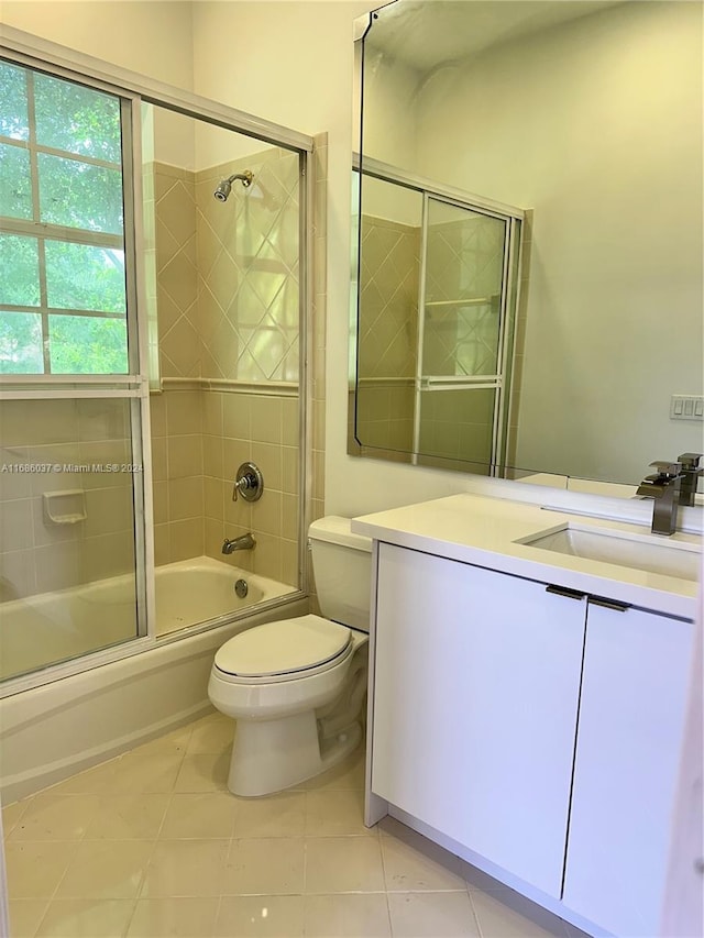 full bathroom featuring tile patterned flooring, vanity, enclosed tub / shower combo, and toilet