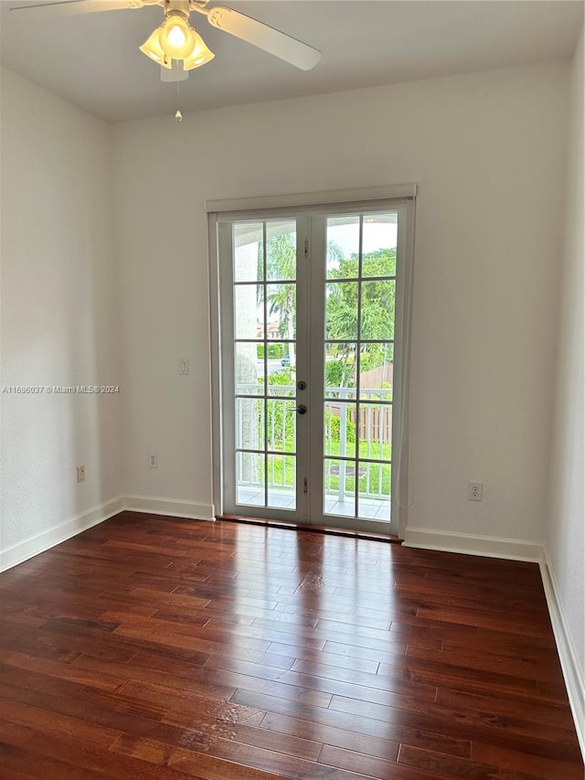 empty room with french doors, dark hardwood / wood-style floors, and ceiling fan