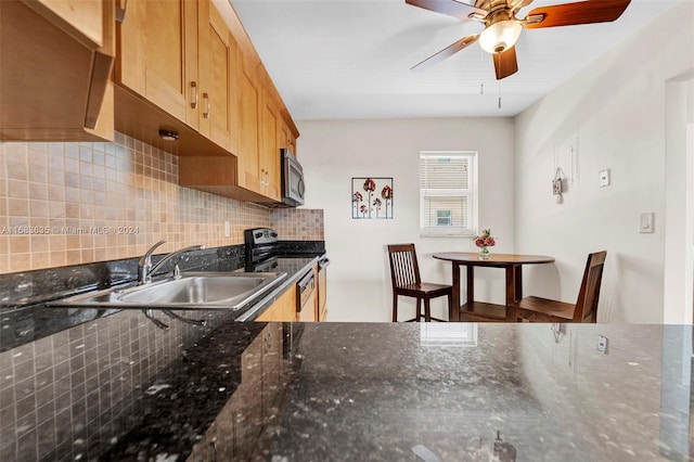 kitchen featuring ceiling fan, backsplash, dark stone counters, sink, and stainless steel appliances