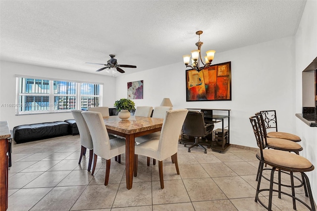 dining space with light tile patterned flooring, a textured ceiling, and ceiling fan with notable chandelier