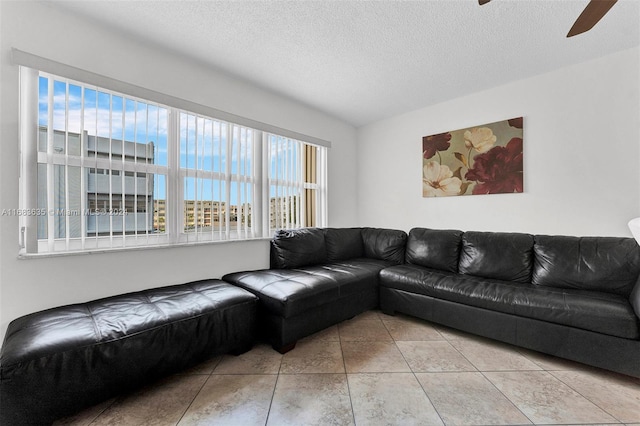 living room with a textured ceiling, a healthy amount of sunlight, and ceiling fan