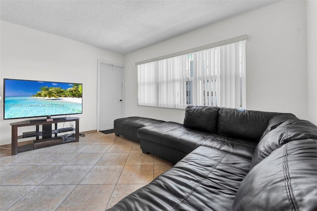 tiled living room featuring a textured ceiling