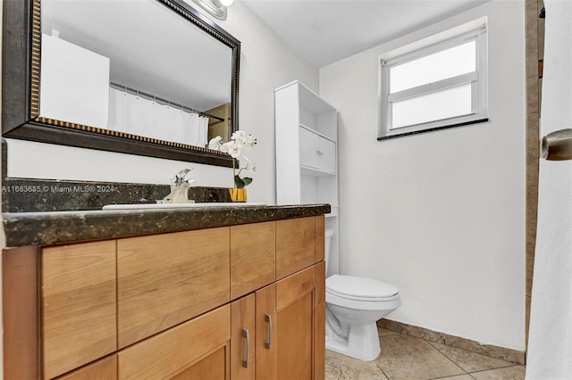 bathroom with vanity, toilet, and tile patterned flooring