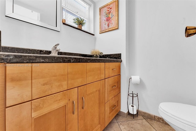 bathroom featuring vanity, toilet, and tile patterned flooring