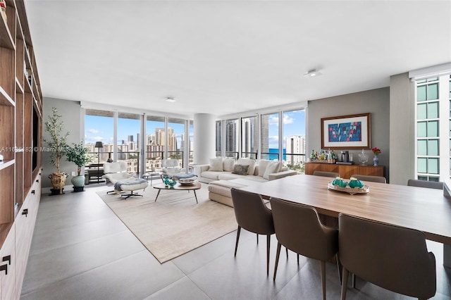 dining space featuring a city view, a wealth of natural light, and floor to ceiling windows