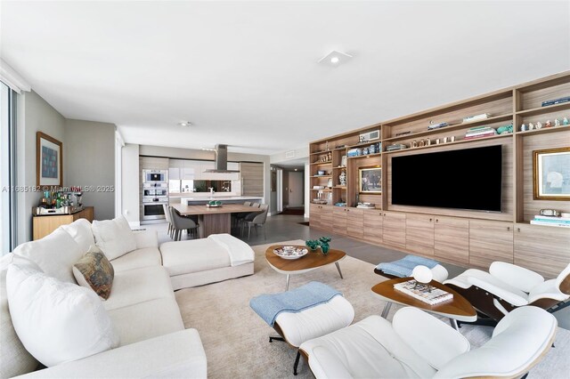 kitchen featuring floor to ceiling windows, island range hood, a kitchen island, and black electric cooktop