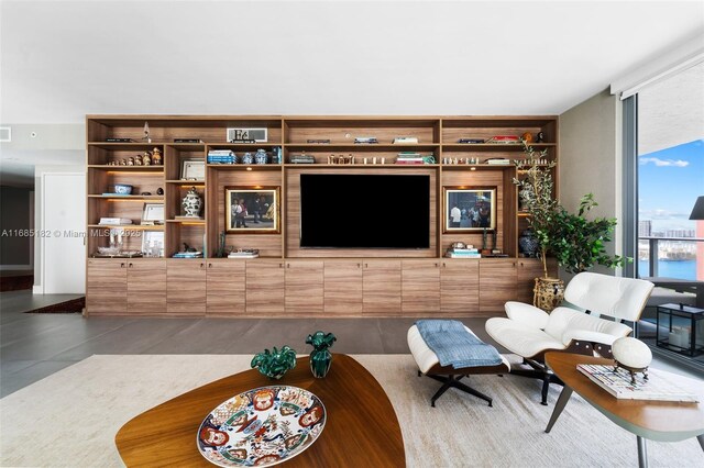 kitchen featuring expansive windows, black electric stovetop, island exhaust hood, and a kitchen island