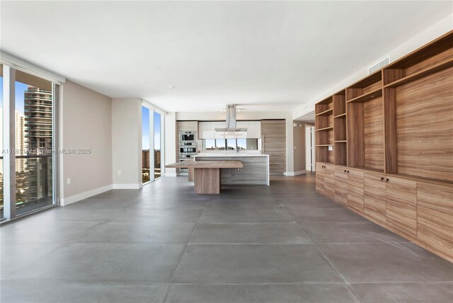 living room featuring a wall of windows and plenty of natural light