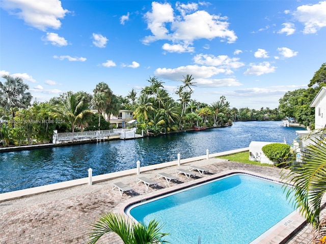 view of swimming pool featuring a water view