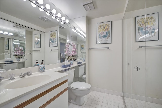 bathroom featuring tile patterned flooring, vanity, and toilet