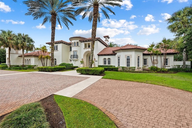 mediterranean / spanish home featuring a front yard