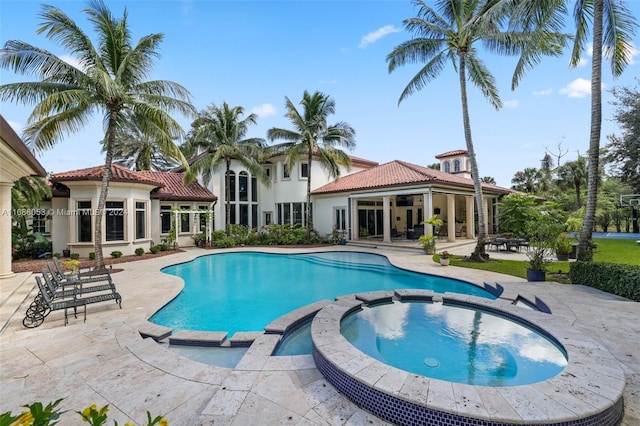 view of pool featuring an in ground hot tub and a patio