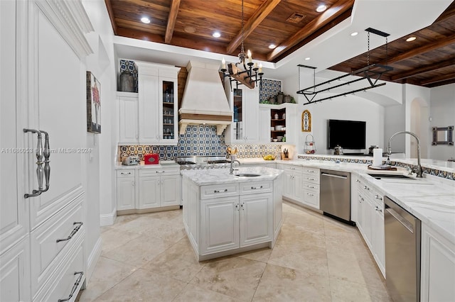 kitchen featuring stainless steel dishwasher, white cabinets, wooden ceiling, and a kitchen island with sink