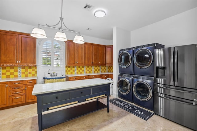 clothes washing area featuring stacked washer / dryer