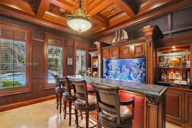 bar with beam ceiling, ornamental molding, hanging light fixtures, and coffered ceiling