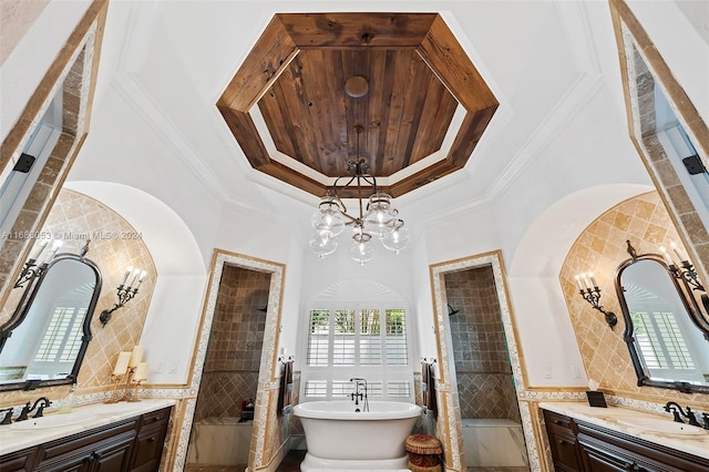 bathroom featuring ornamental molding, vanity, an inviting chandelier, tile walls, and independent shower and bath