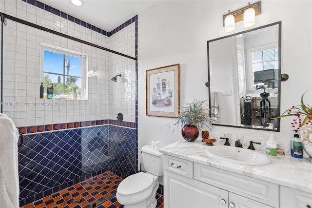 bathroom featuring walk in shower, plenty of natural light, vanity, and toilet