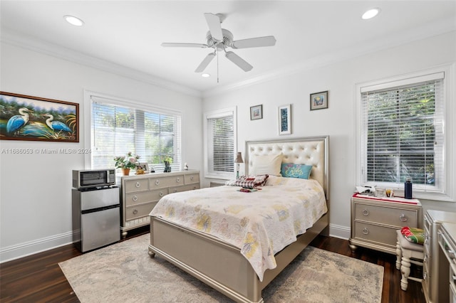 bedroom featuring ceiling fan, dark hardwood / wood-style floors, ornamental molding, and multiple windows