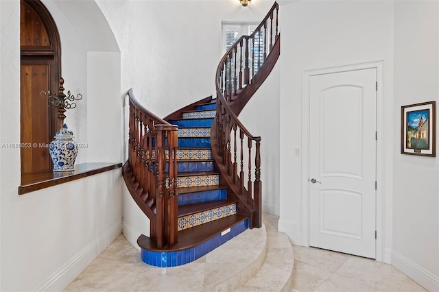 stairs featuring tile patterned flooring