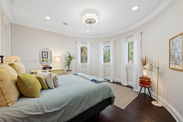 bedroom with dark hardwood / wood-style floors and ornamental molding