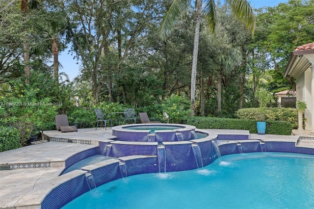 view of swimming pool with an in ground hot tub, pool water feature, and a patio area