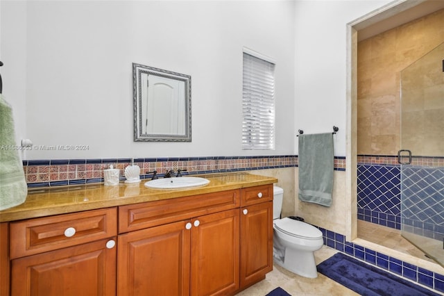 bathroom featuring tile patterned floors, walk in shower, vanity, tile walls, and toilet