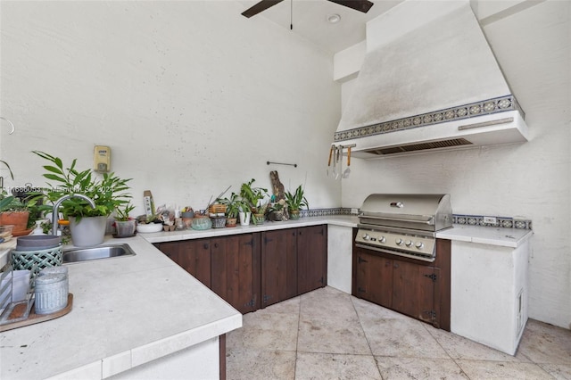 view of patio featuring a grill, sink, and an outdoor kitchen