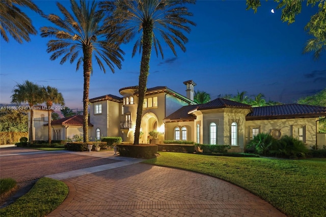 mediterranean / spanish-style house featuring a yard