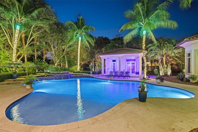 view of pool with pool water feature and a patio