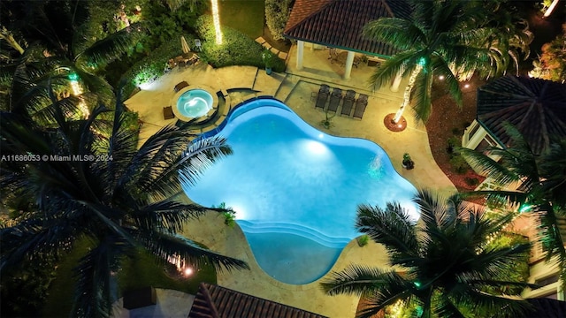 view of pool featuring an in ground hot tub and a patio