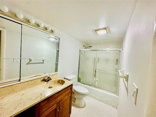 full bathroom with vanity, toilet, and shower / bath combination with glass door