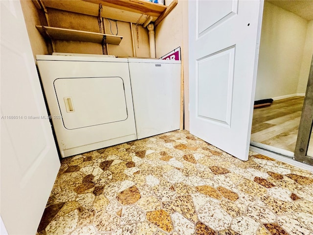 clothes washing area with washer and dryer and wood-type flooring