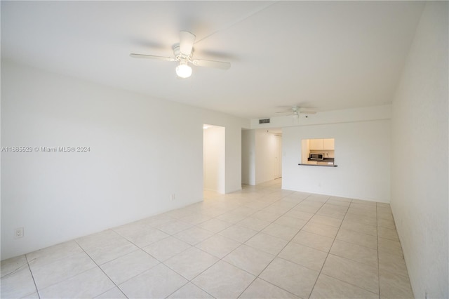 spare room with light tile patterned floors and ceiling fan