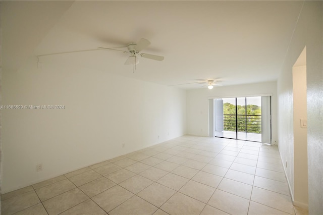 empty room with ceiling fan and light tile patterned floors