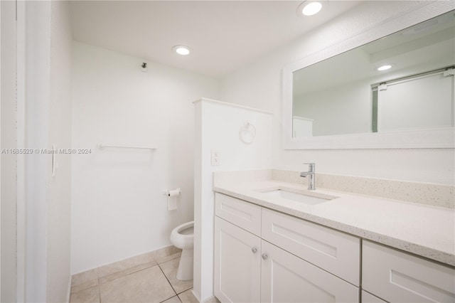 bathroom featuring vanity, tile patterned floors, and toilet